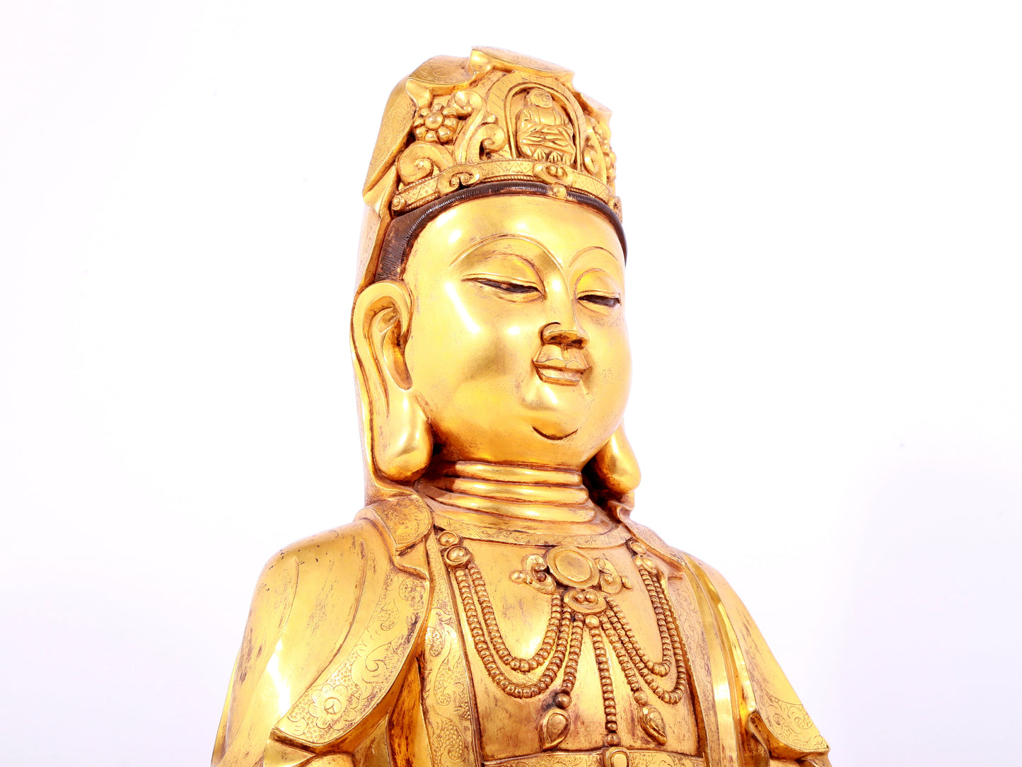 A solemn gilt bronze statue of Guanyin