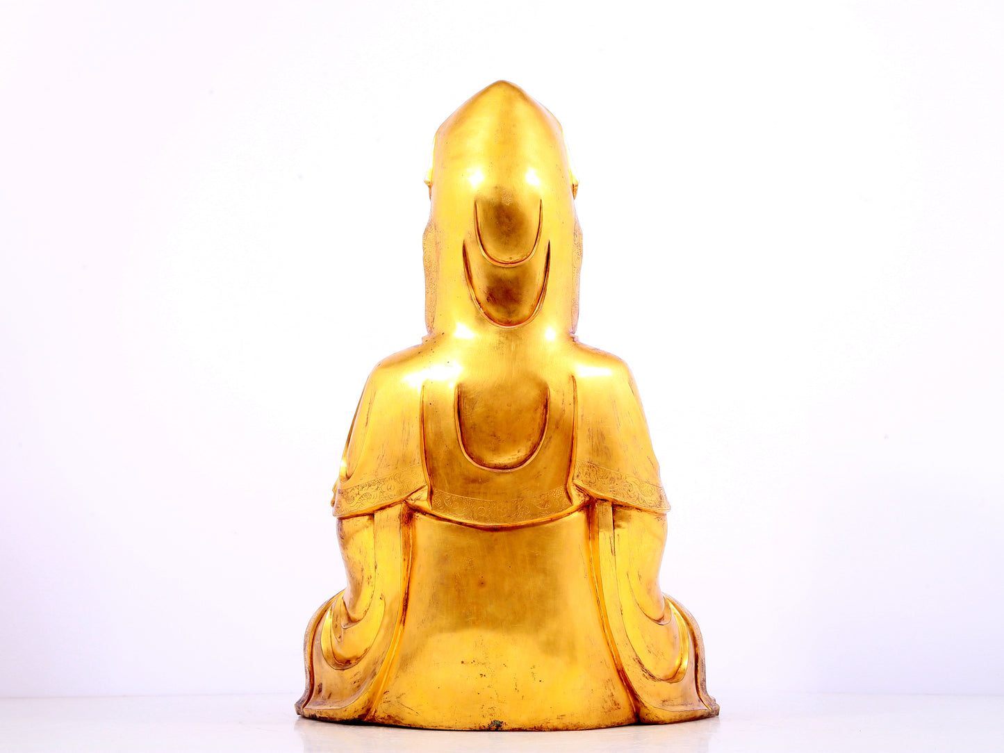 A solemn gilt bronze statue of Guanyin