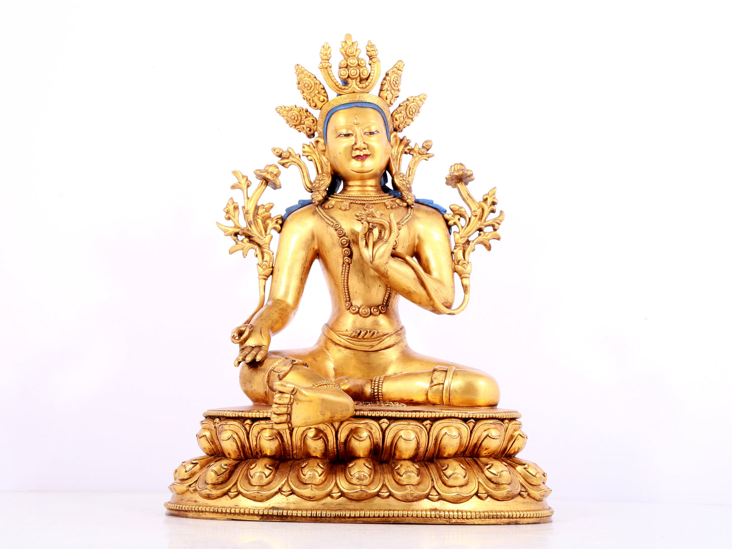 A solemn gilt bronze statue of green Tara