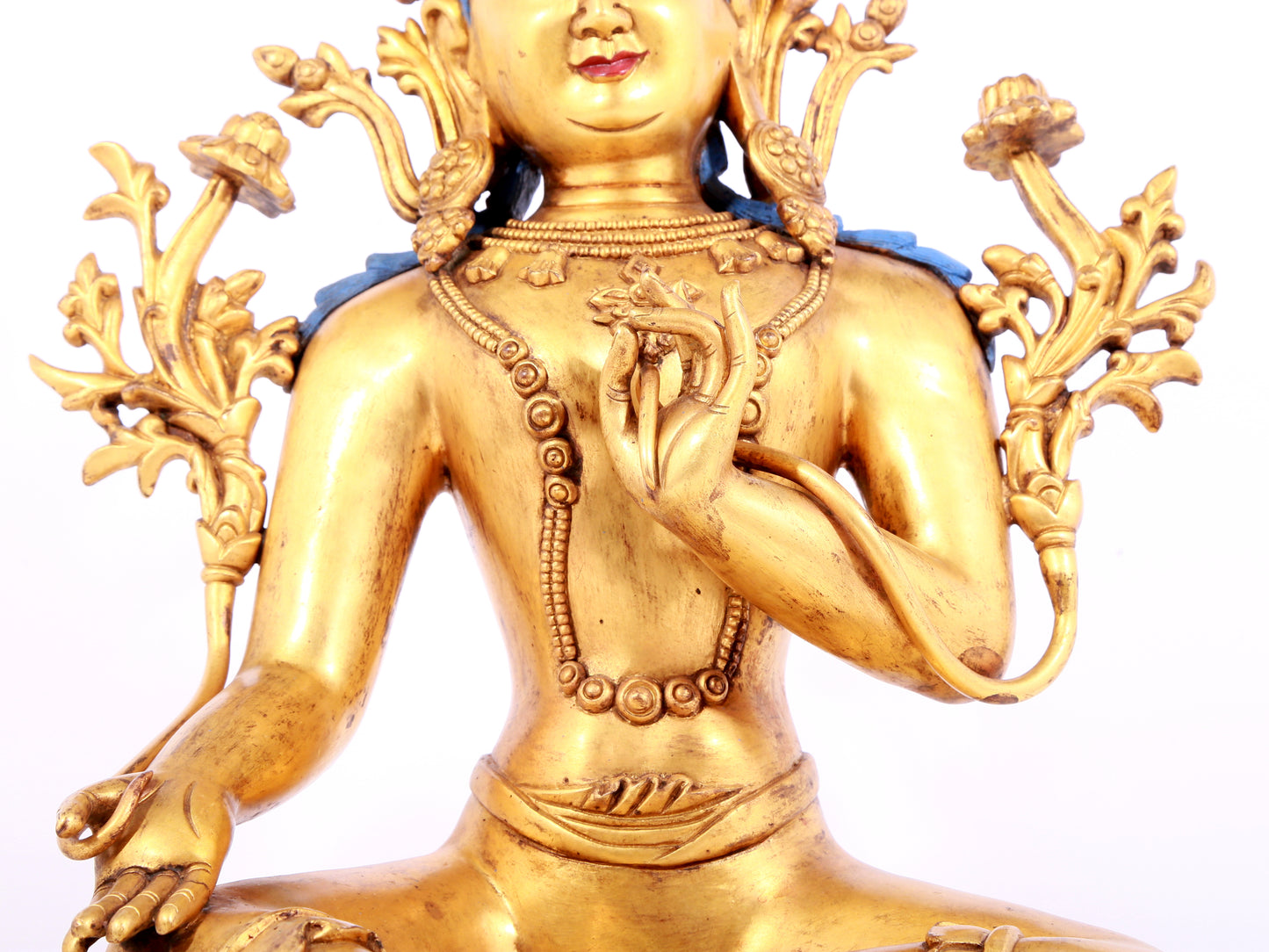 A solemn gilt bronze statue of green Tara