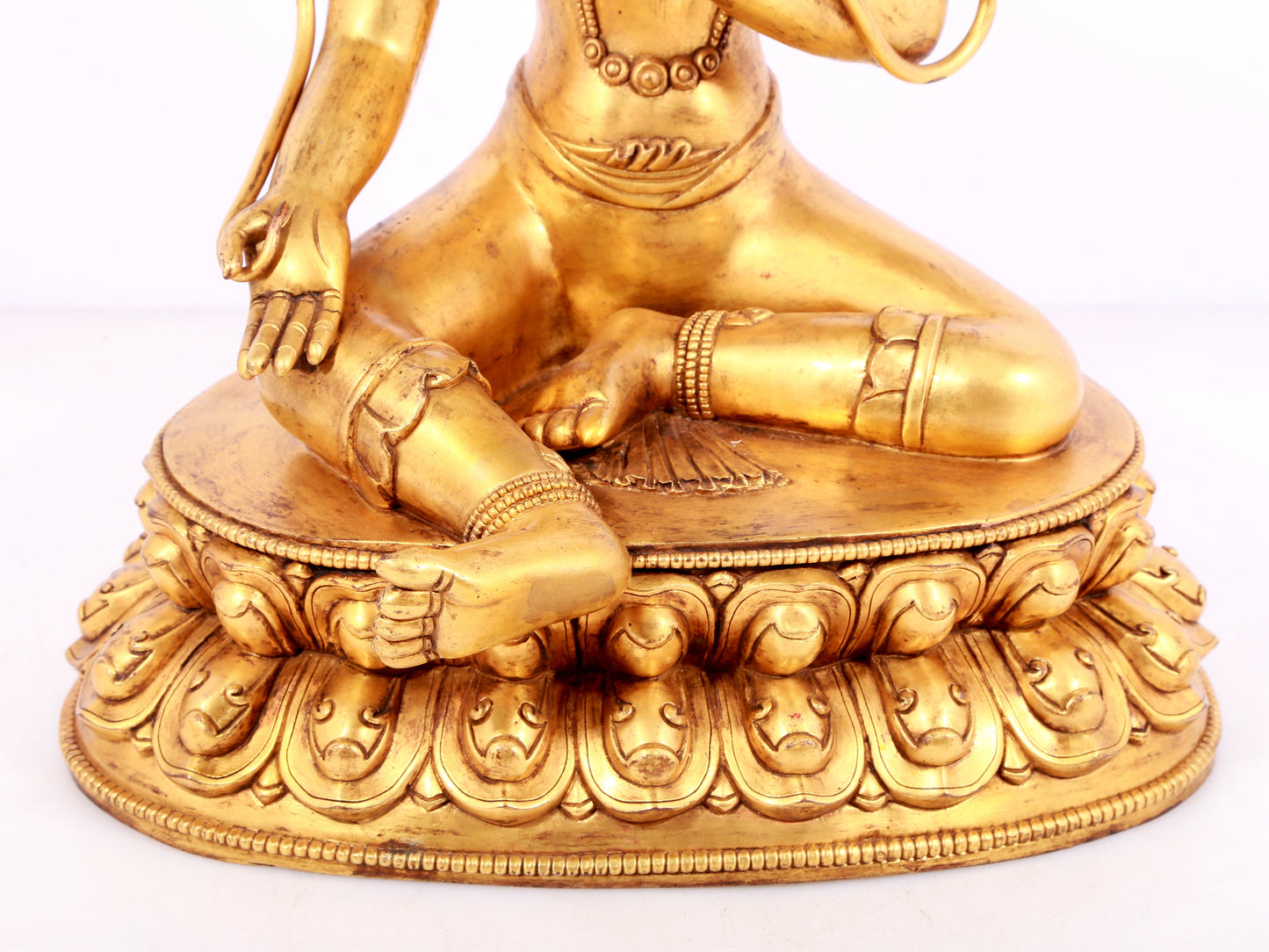 A solemn gilt bronze statue of green Tara