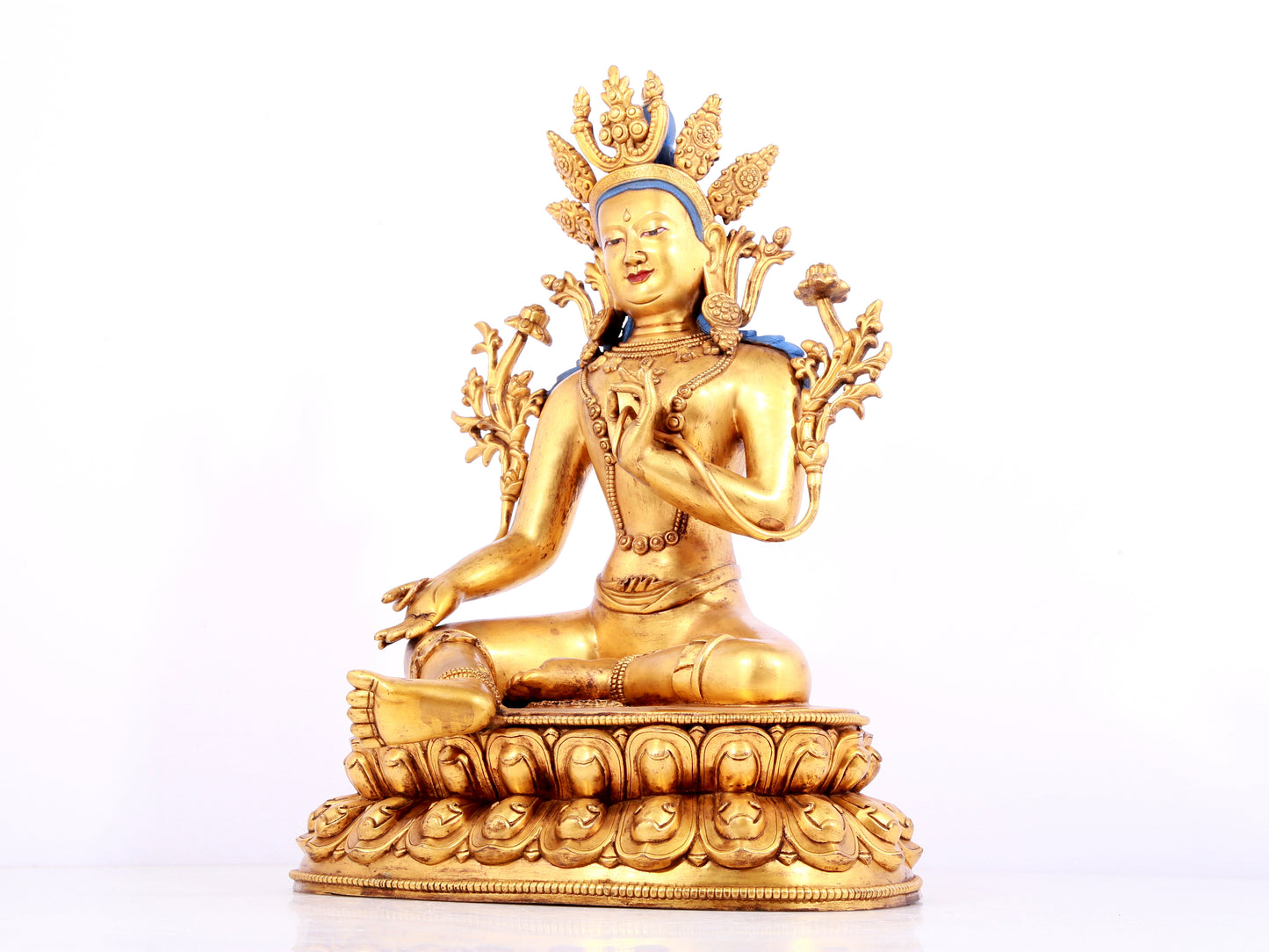 A solemn gilt bronze statue of green Tara