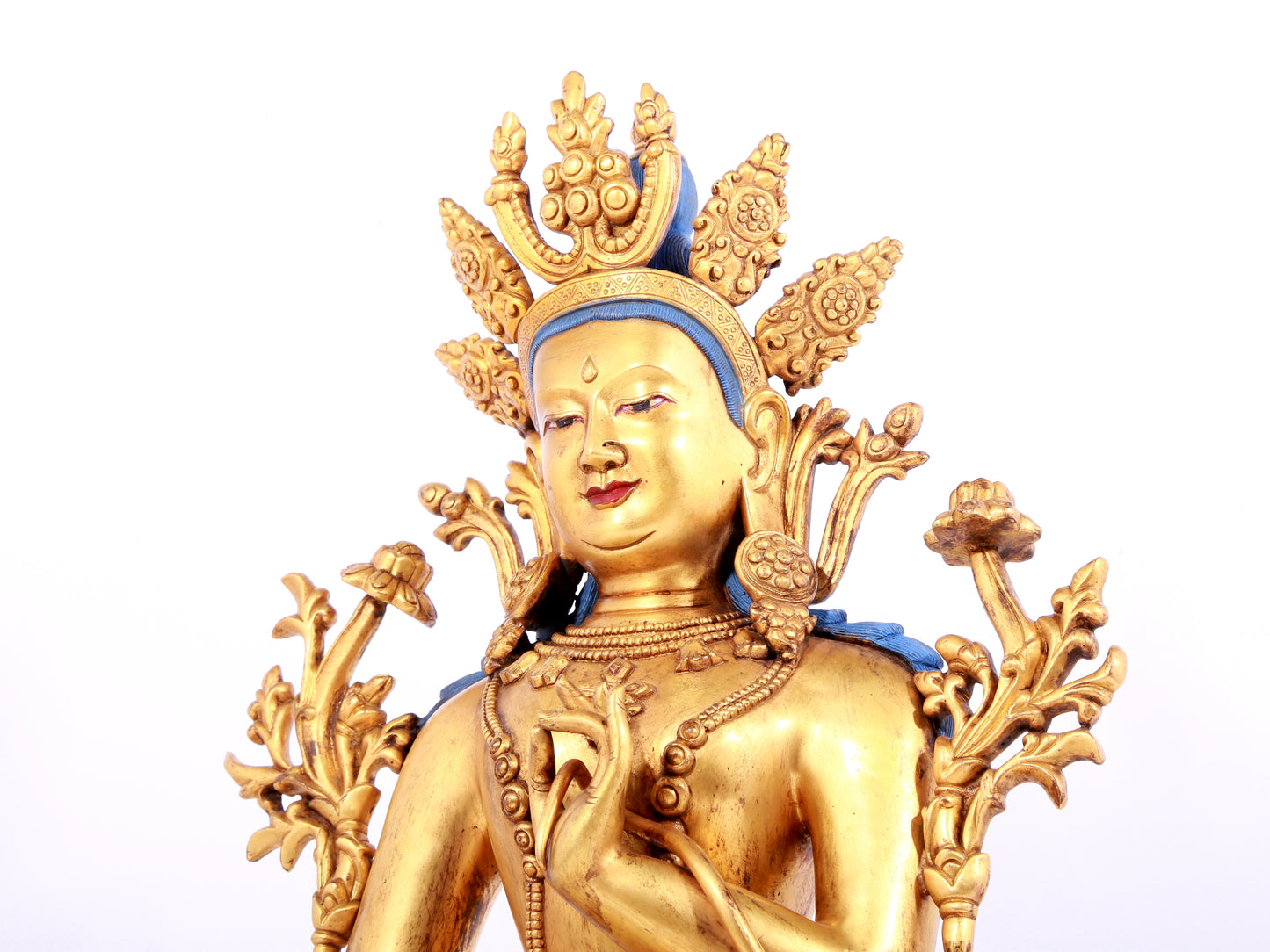 A solemn gilt bronze statue of green Tara