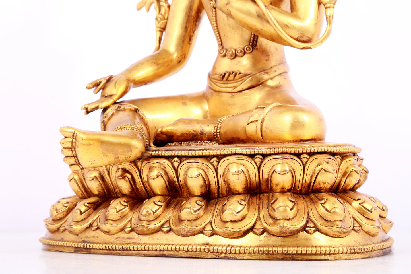 A solemn gilt bronze statue of green Tara