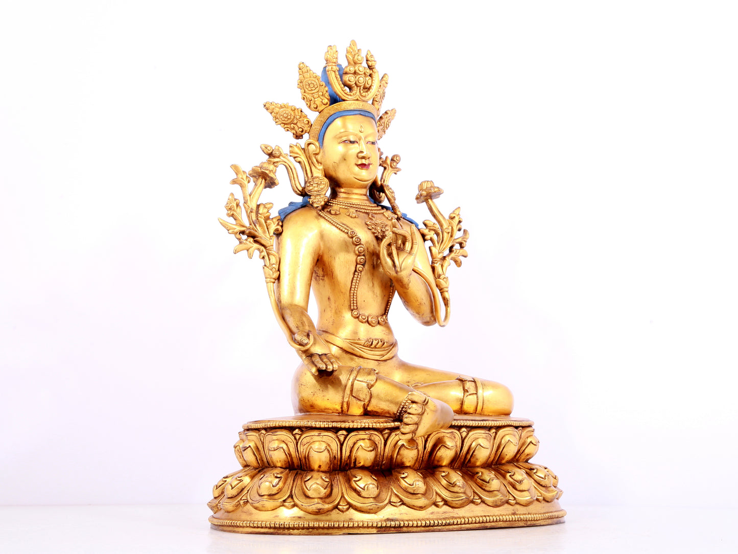 A solemn gilt bronze statue of green Tara