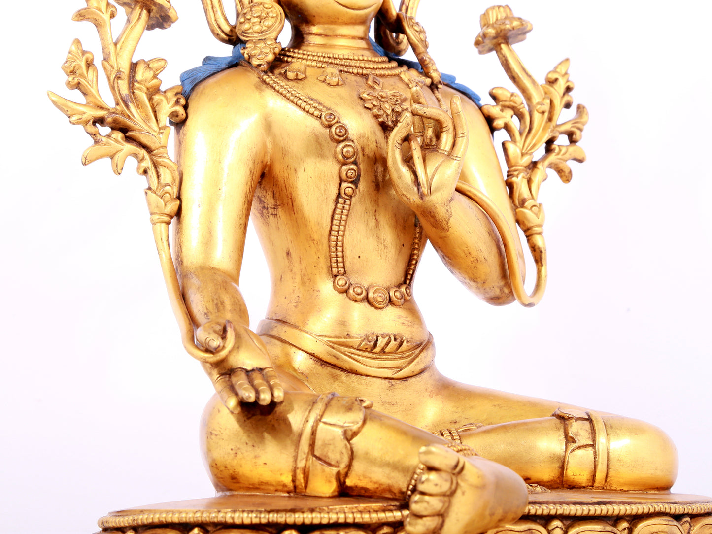 A solemn gilt bronze statue of green Tara