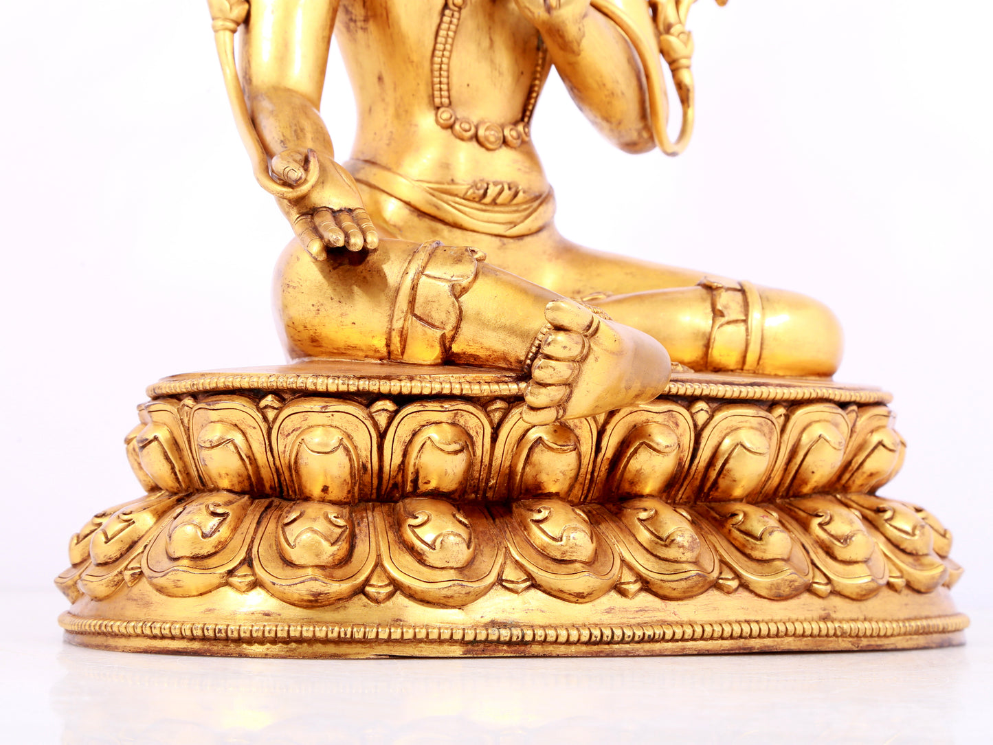 A solemn gilt bronze statue of green Tara