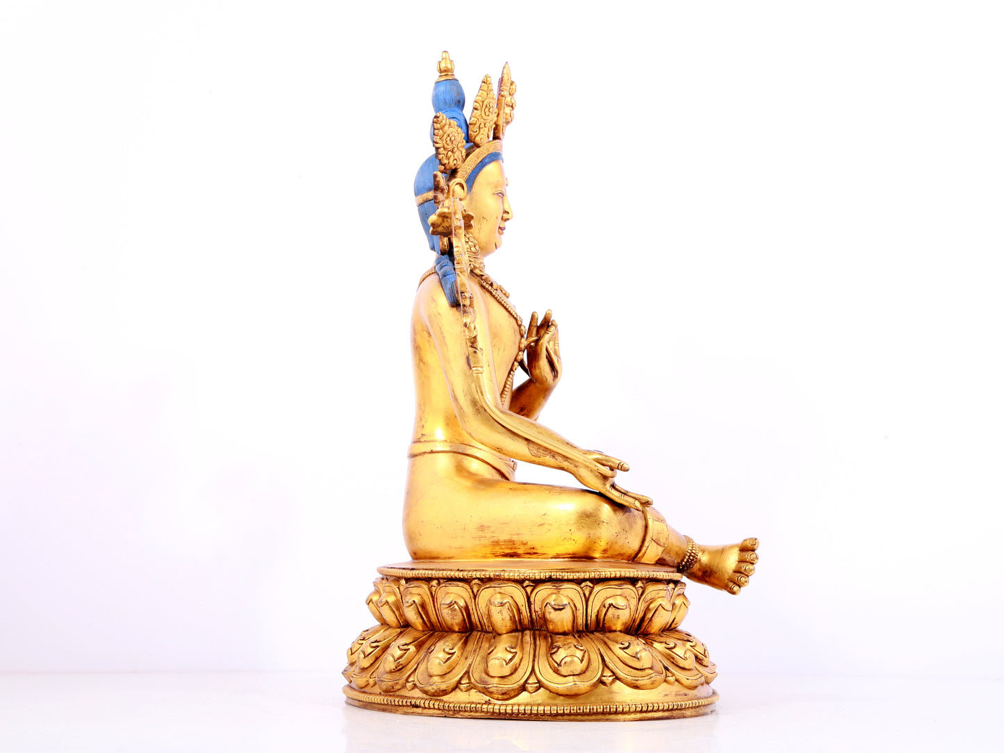 A solemn gilt bronze statue of green Tara