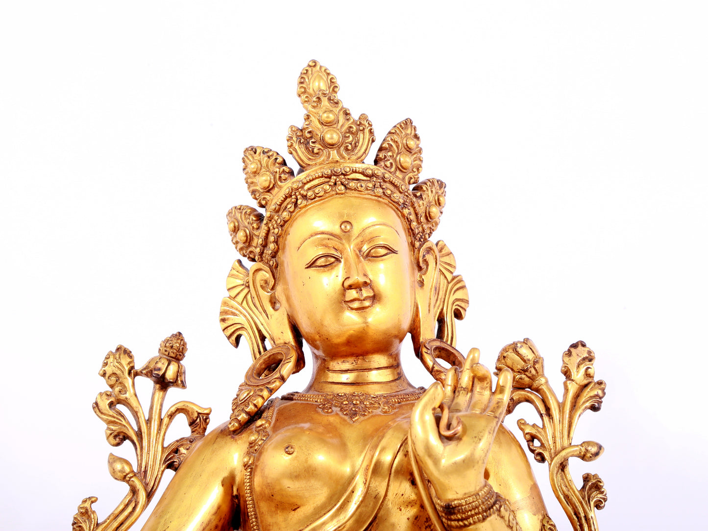 A solemn gilt bronze statue of green Tara