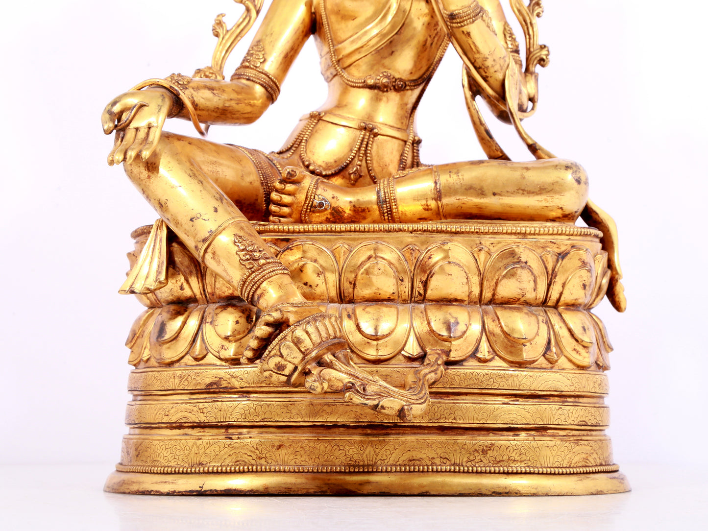 A solemn gilt bronze statue of green Tara