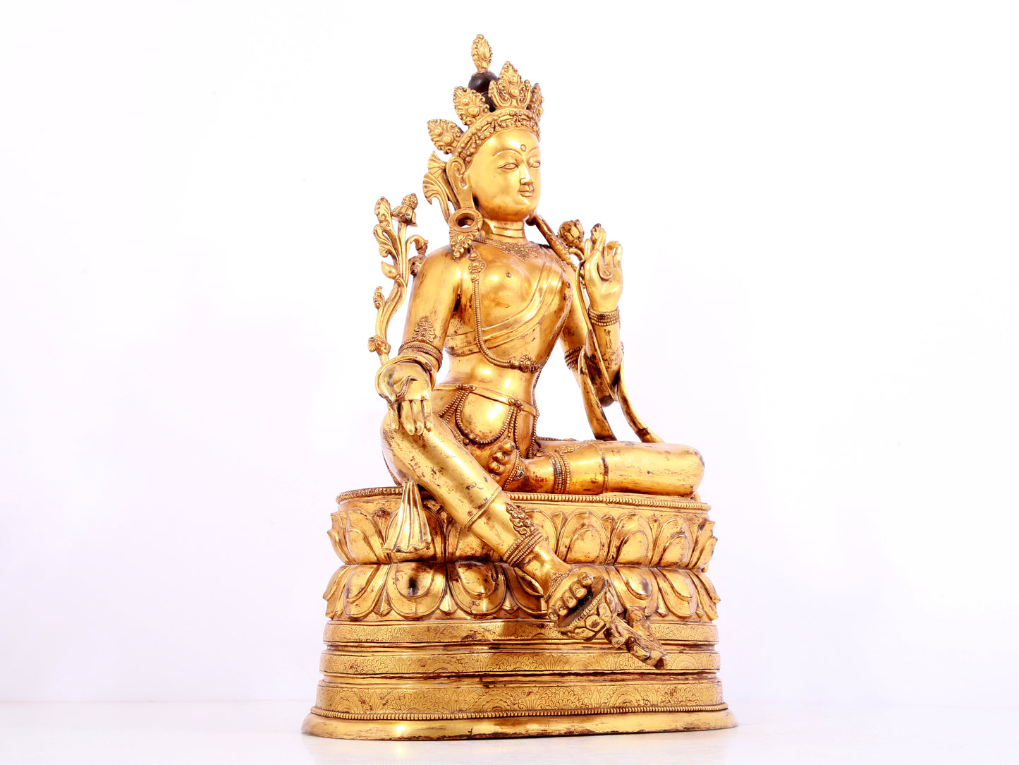 A solemn gilt bronze statue of green Tara