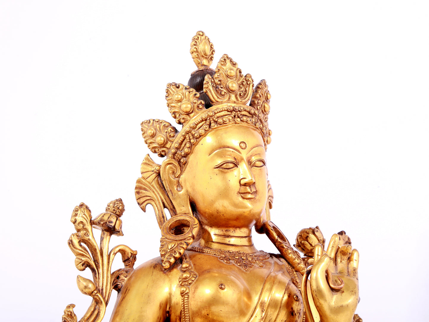 A solemn gilt bronze statue of green Tara