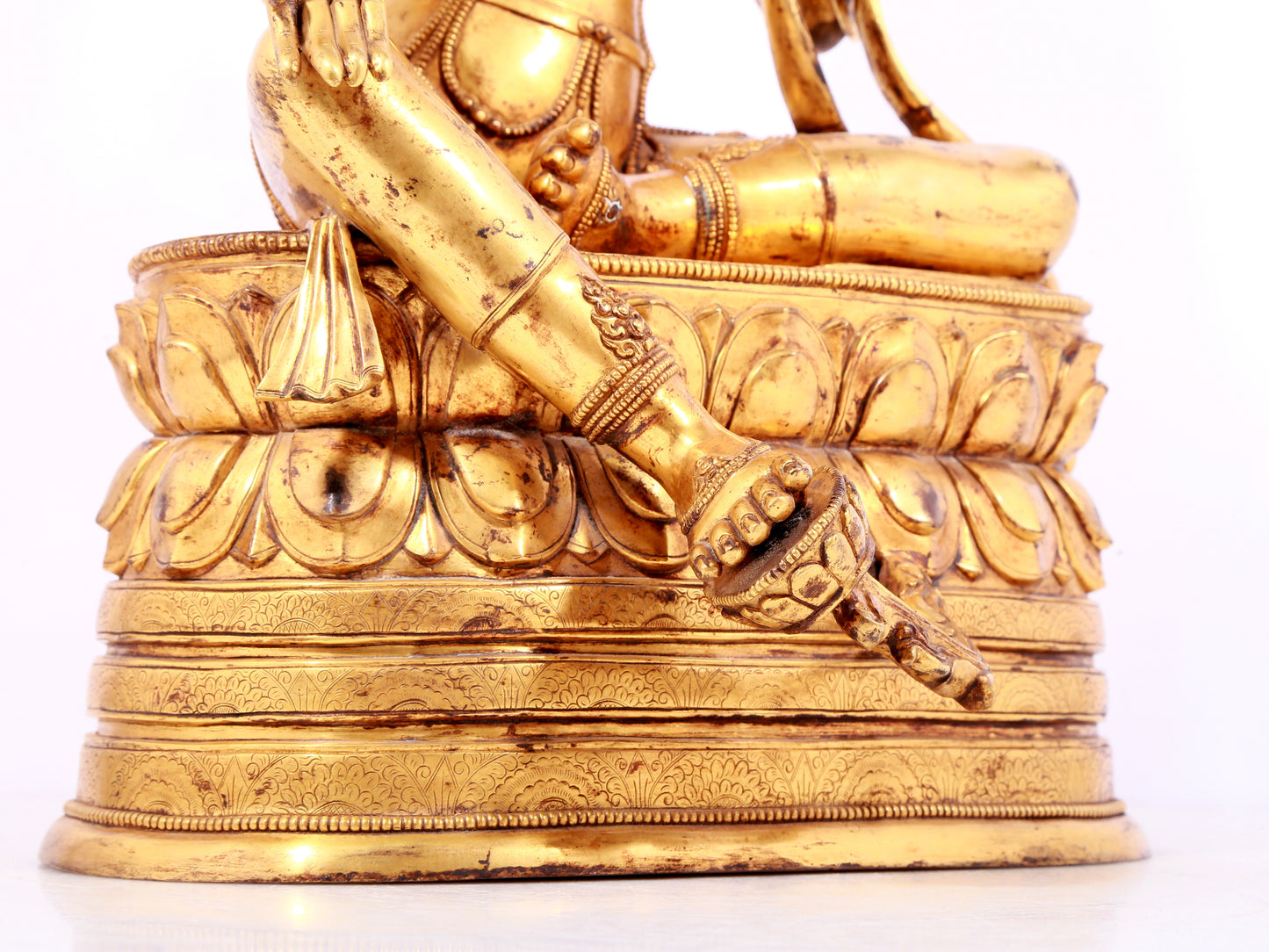 A solemn gilt bronze statue of green Tara