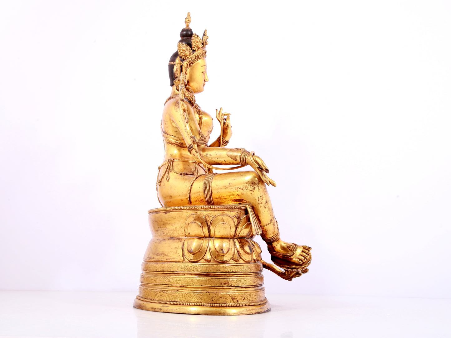 A solemn gilt bronze statue of green Tara