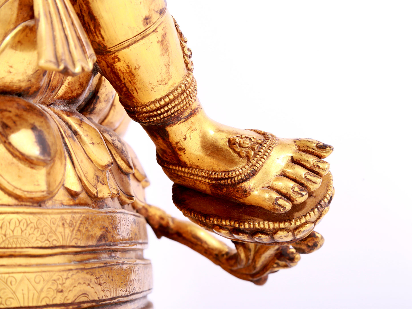 A solemn gilt bronze statue of green Tara