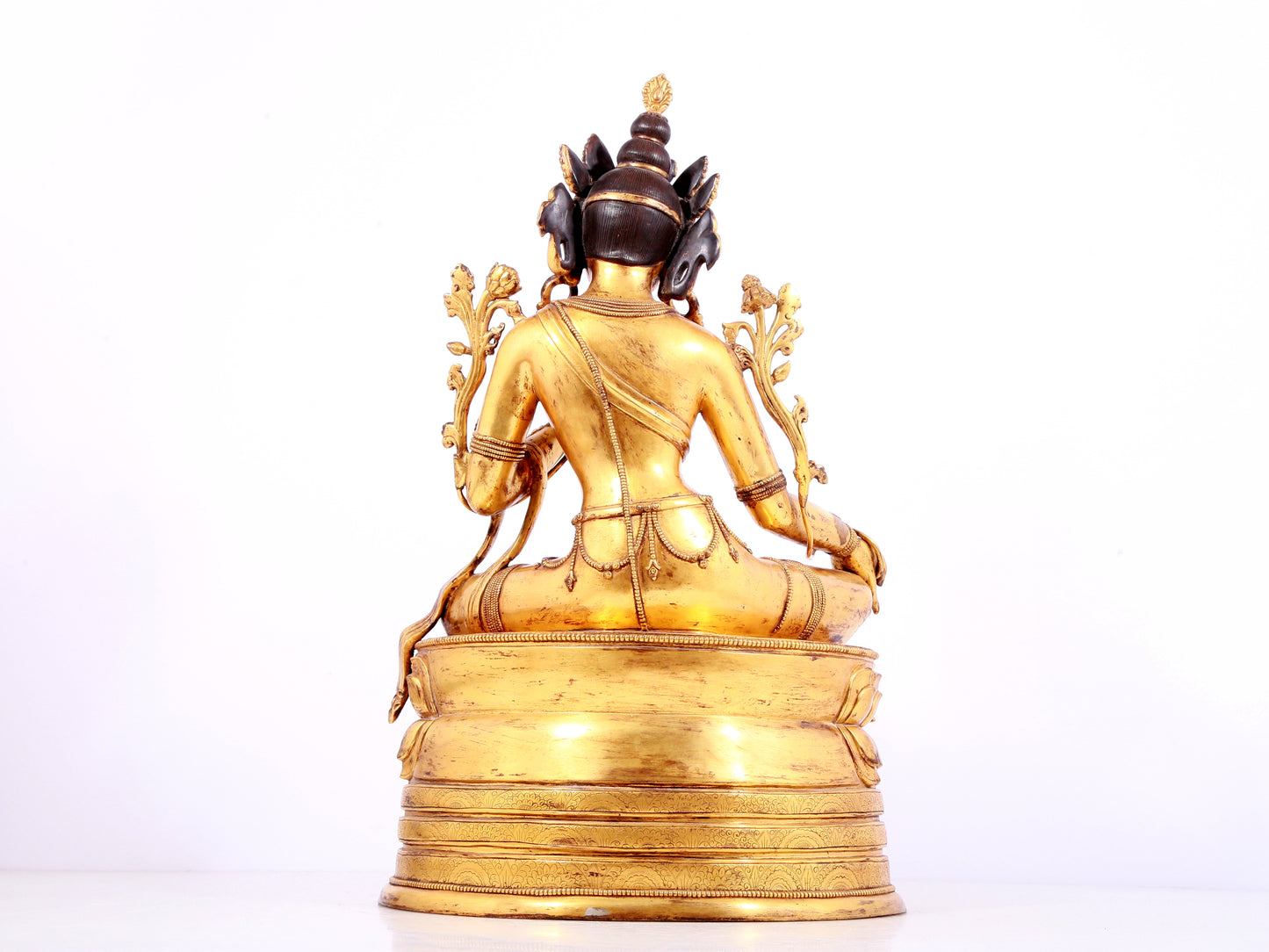 A solemn gilt bronze statue of green Tara