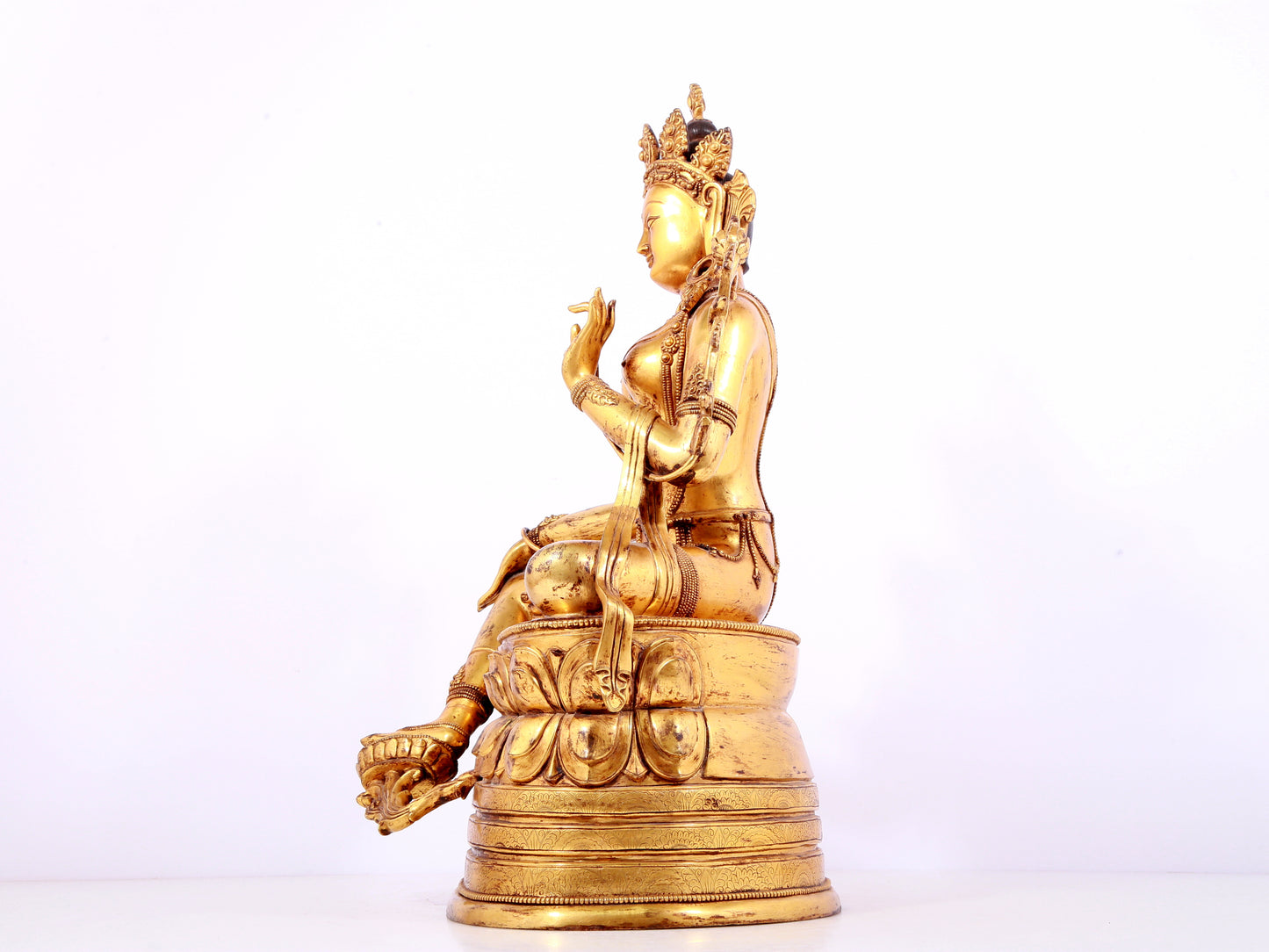 A solemn gilt bronze statue of green Tara