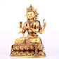 A solemn gilt bronze statue of Guanyin with four arms inlaid gems