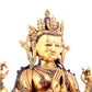 A solemn gilt bronze statue of Guanyin with four arms inlaid gems