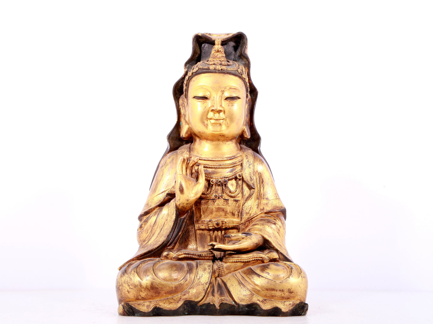 A solemn gilt bronze statue of Guanyin