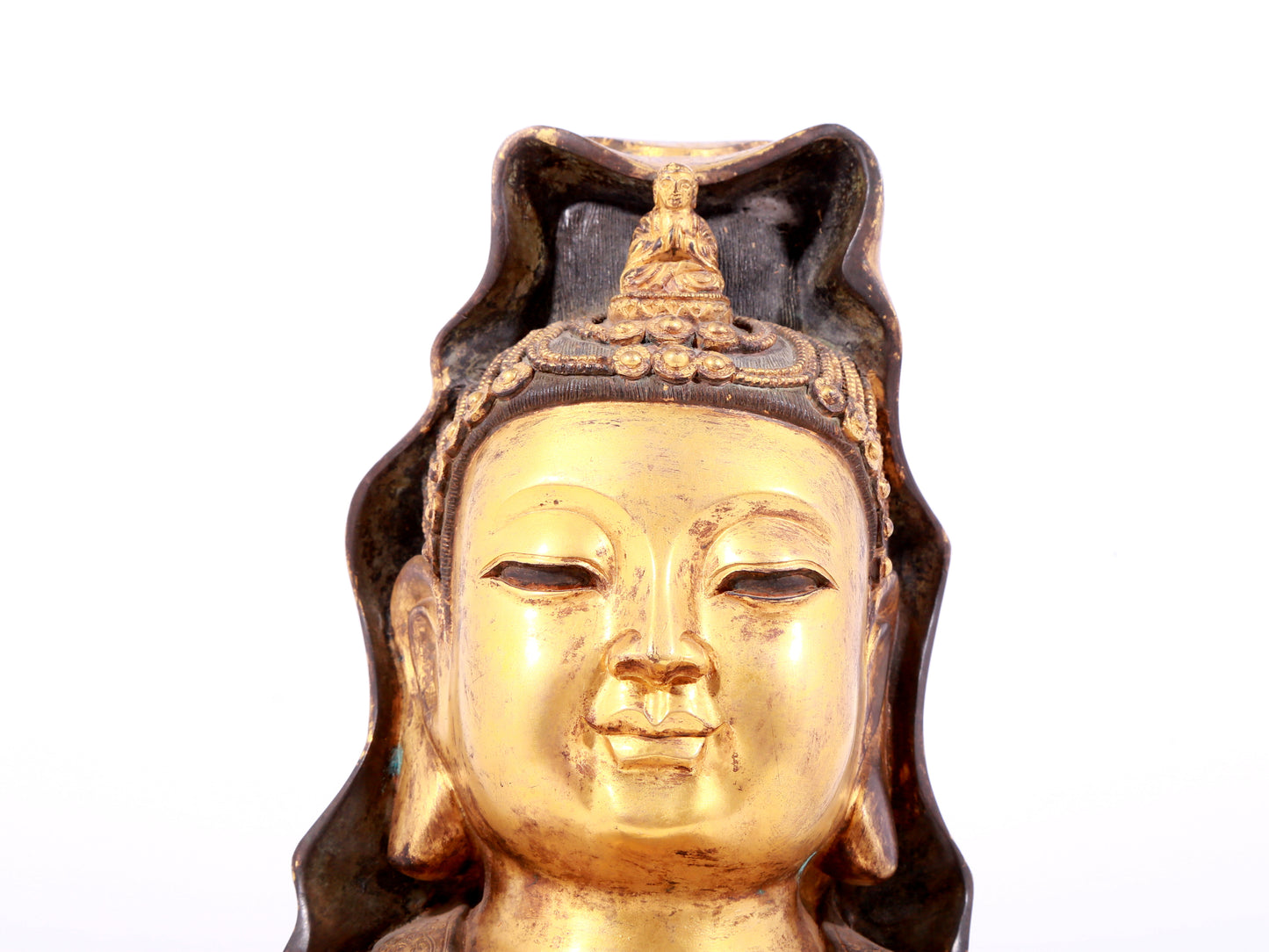 A solemn gilt bronze statue of Guanyin