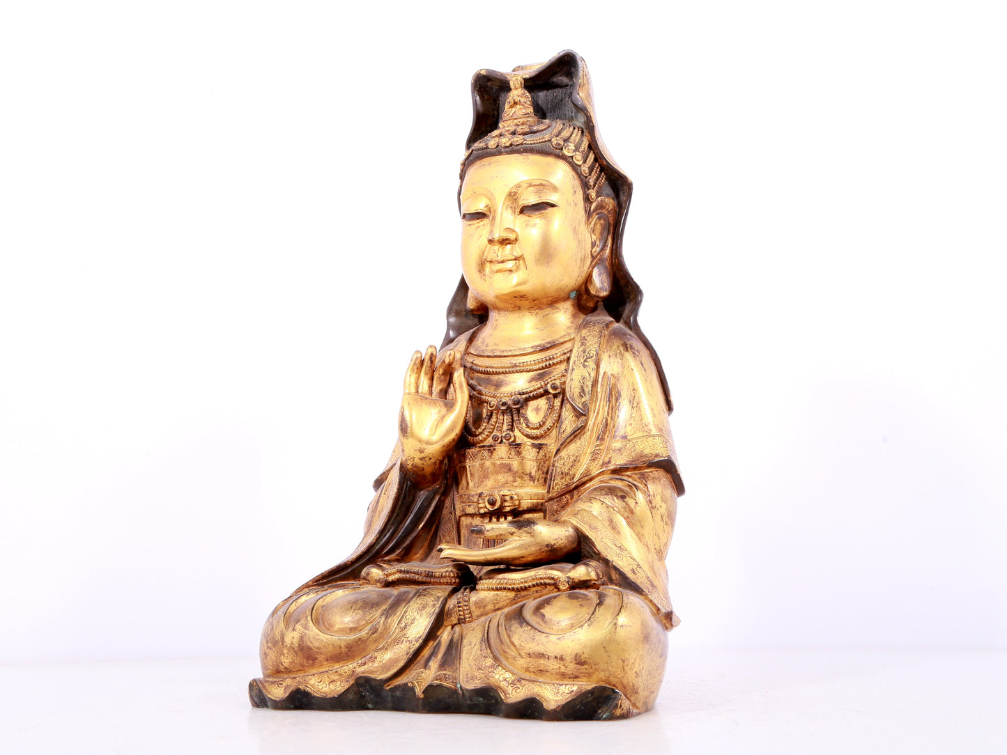 A solemn gilt bronze statue of Guanyin