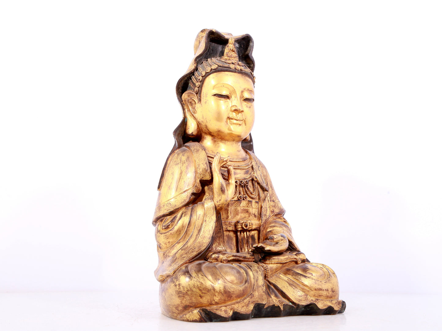 A solemn gilt bronze statue of Guanyin