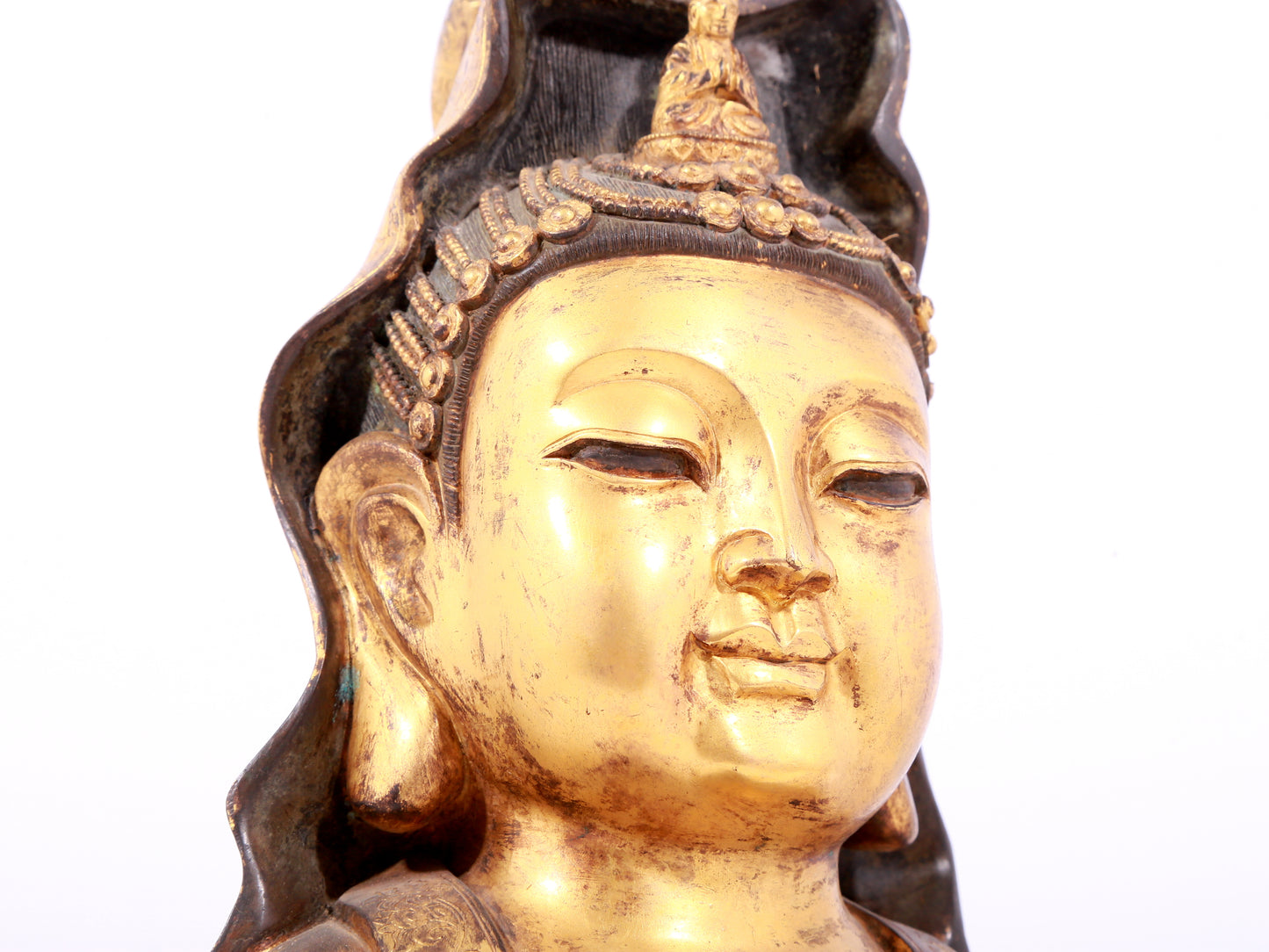 A solemn gilt bronze statue of Guanyin