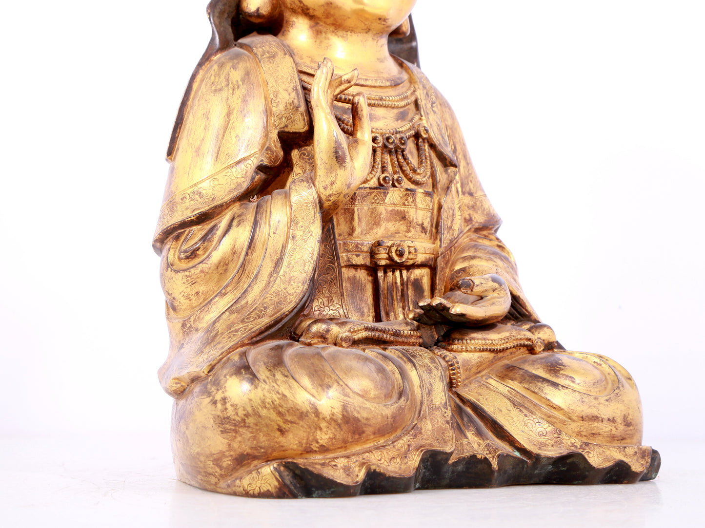 A solemn gilt bronze statue of Guanyin