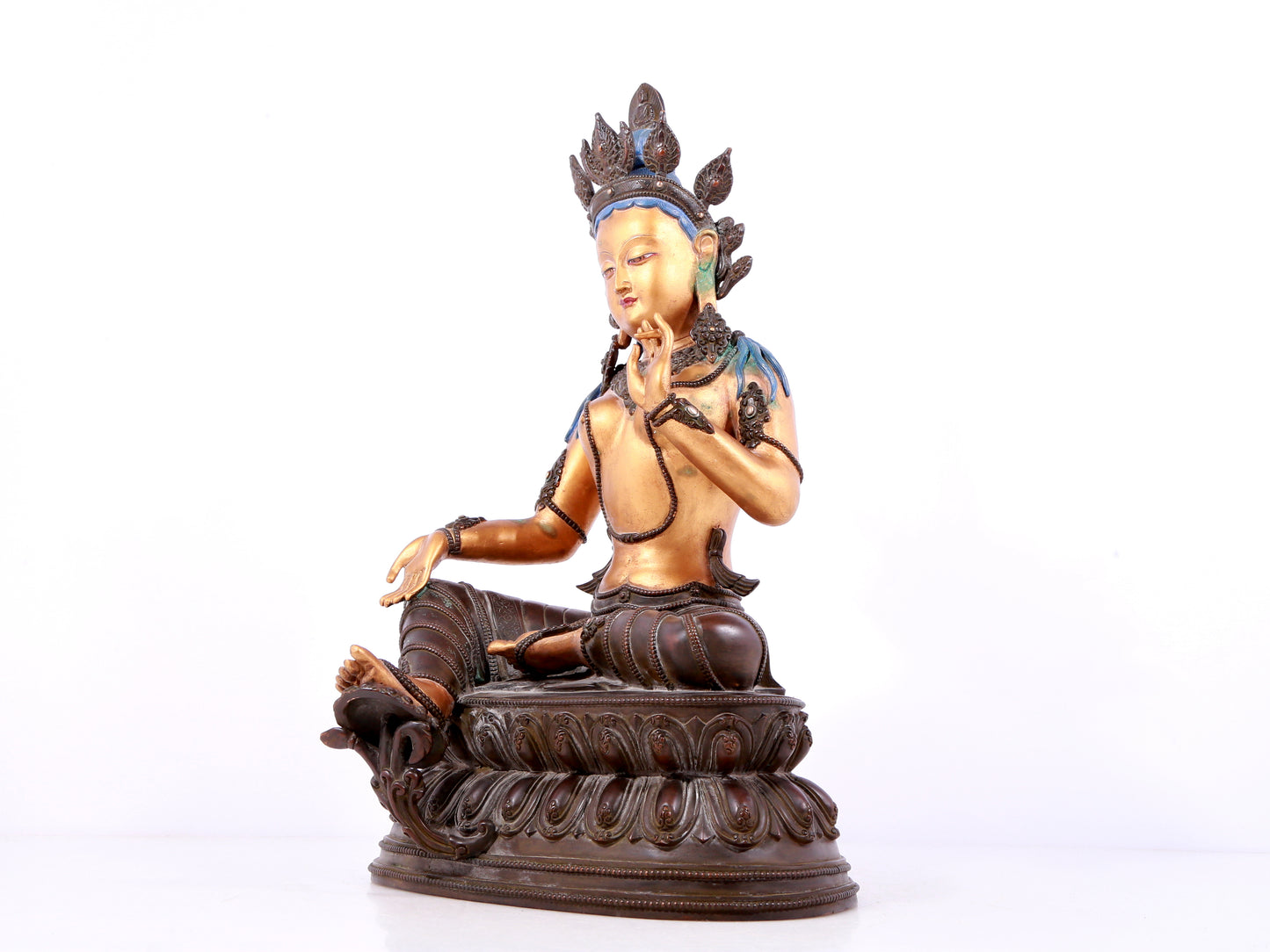 A solemn gilt bronze statue of green Tara