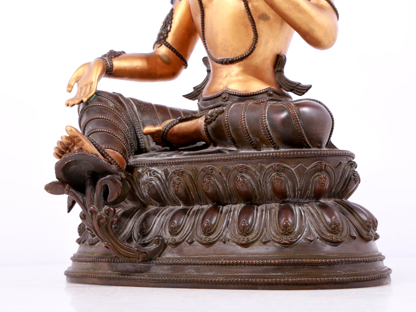 A solemn gilt bronze statue of green Tara