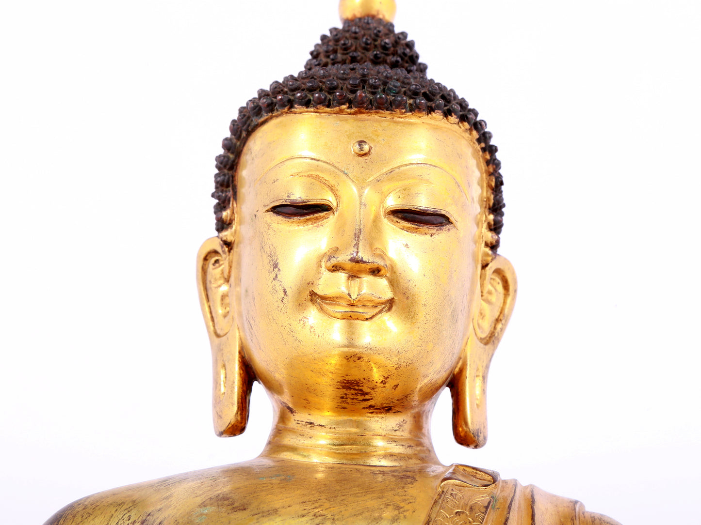 A solemn gilt bronze statue of Sakyamuni