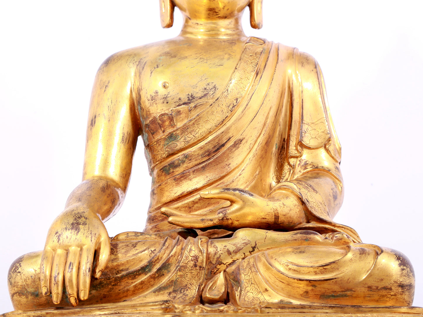 A solemn gilt bronze statue of Sakyamuni