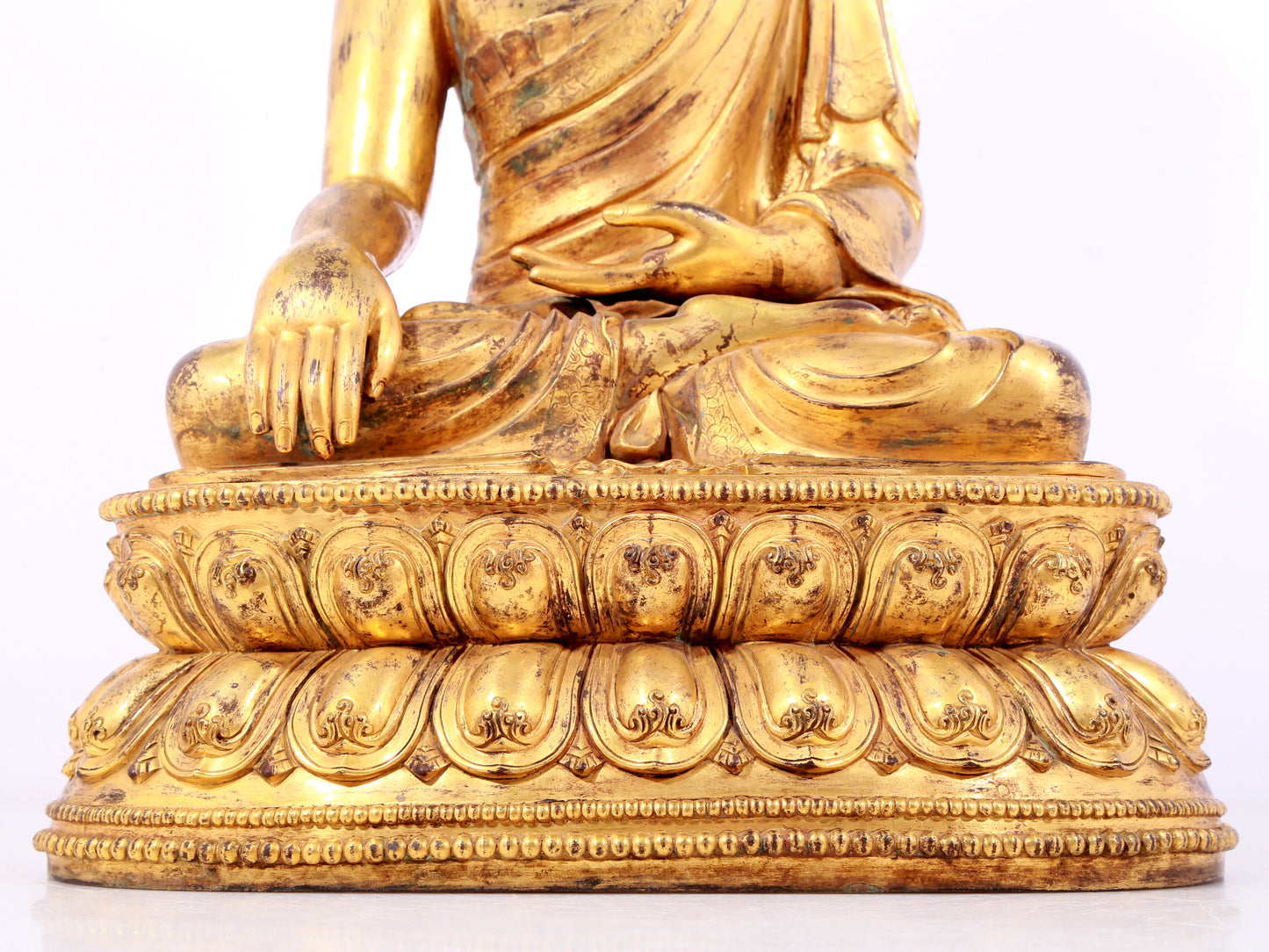 A solemn gilt bronze statue of Sakyamuni