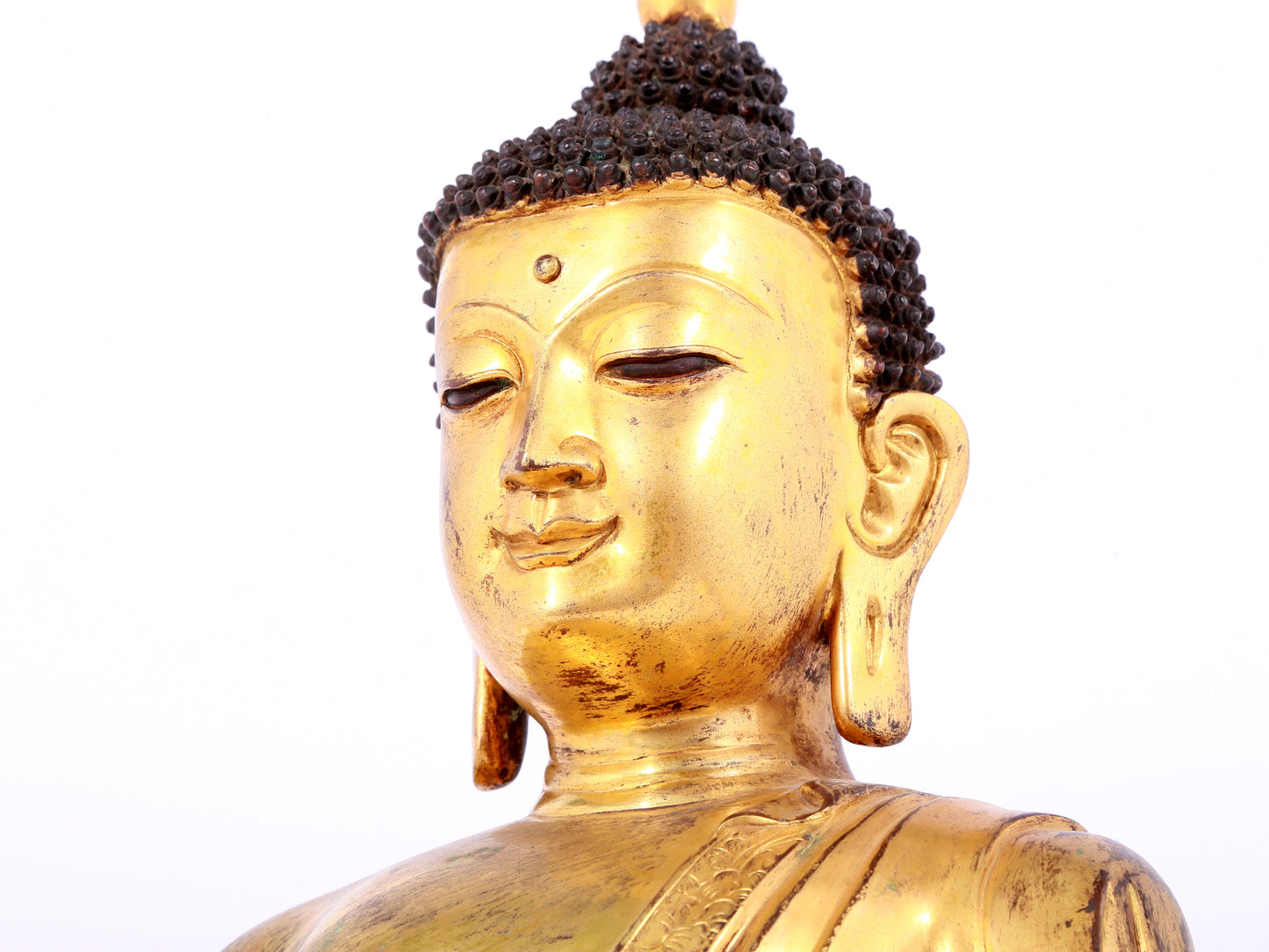 A solemn gilt bronze statue of Sakyamuni