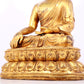 A solemn gilt bronze statue of Sakyamuni