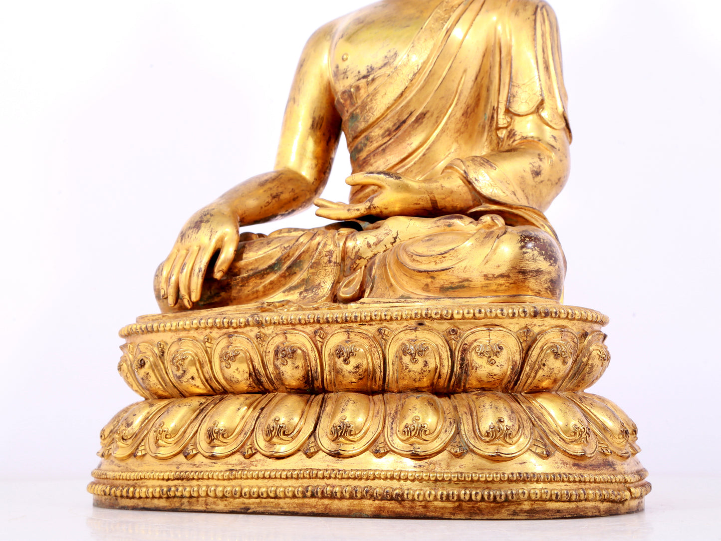 A solemn gilt bronze statue of Sakyamuni