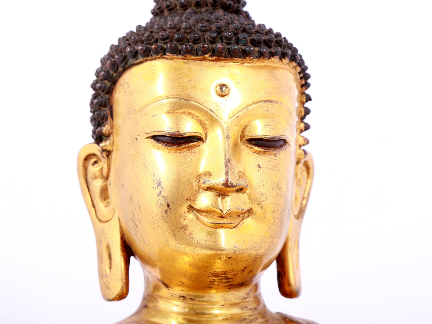 A solemn gilt bronze statue of Sakyamuni