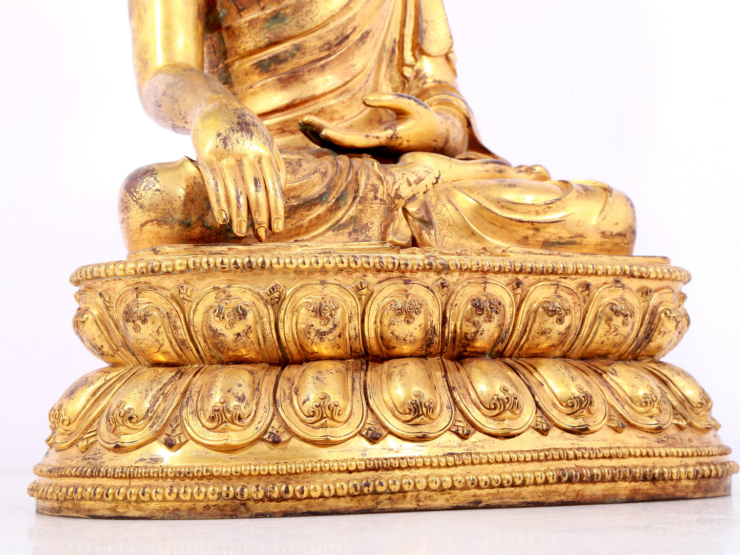 A solemn gilt bronze statue of Sakyamuni