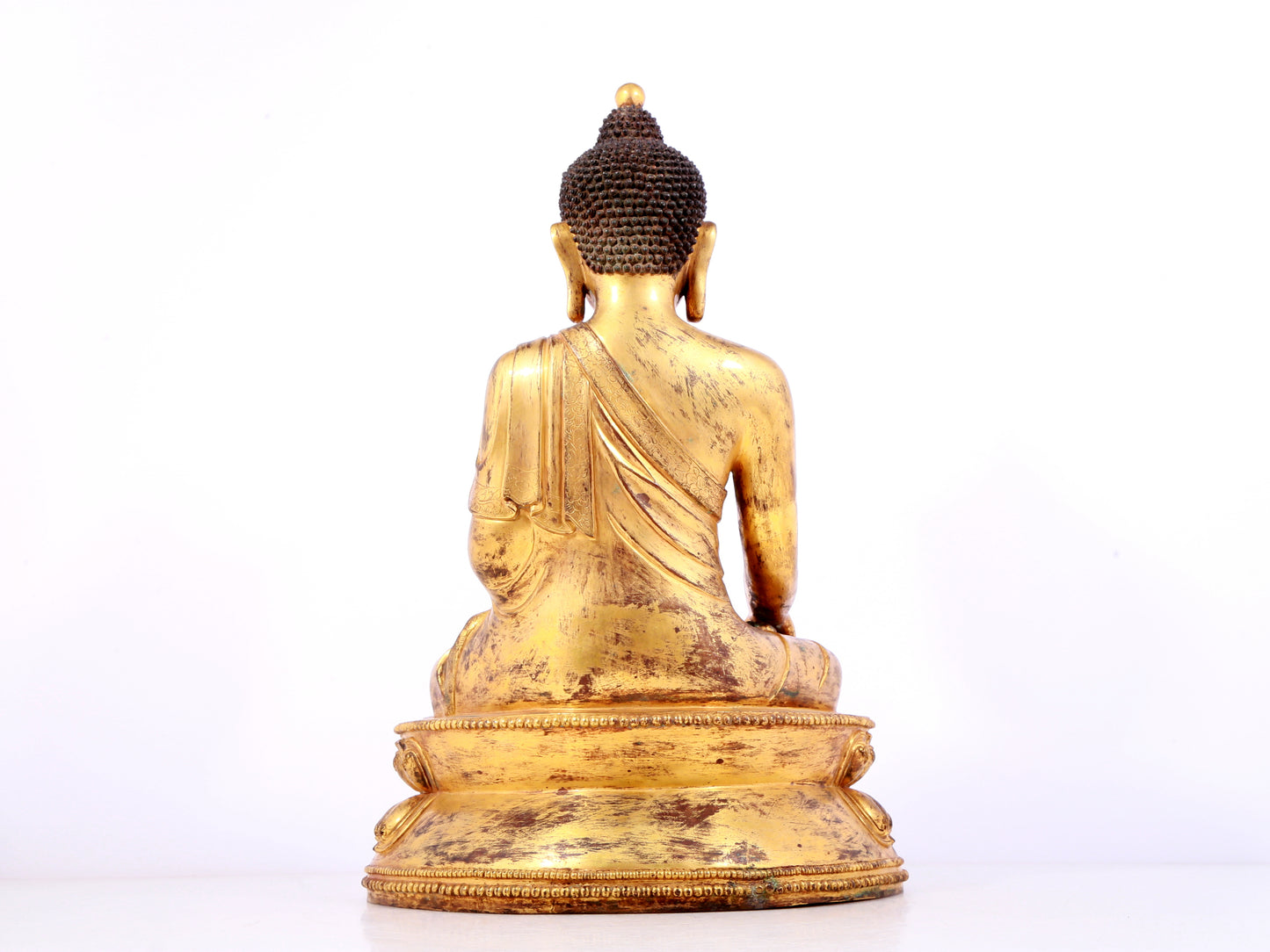 A solemn gilt bronze statue of Sakyamuni