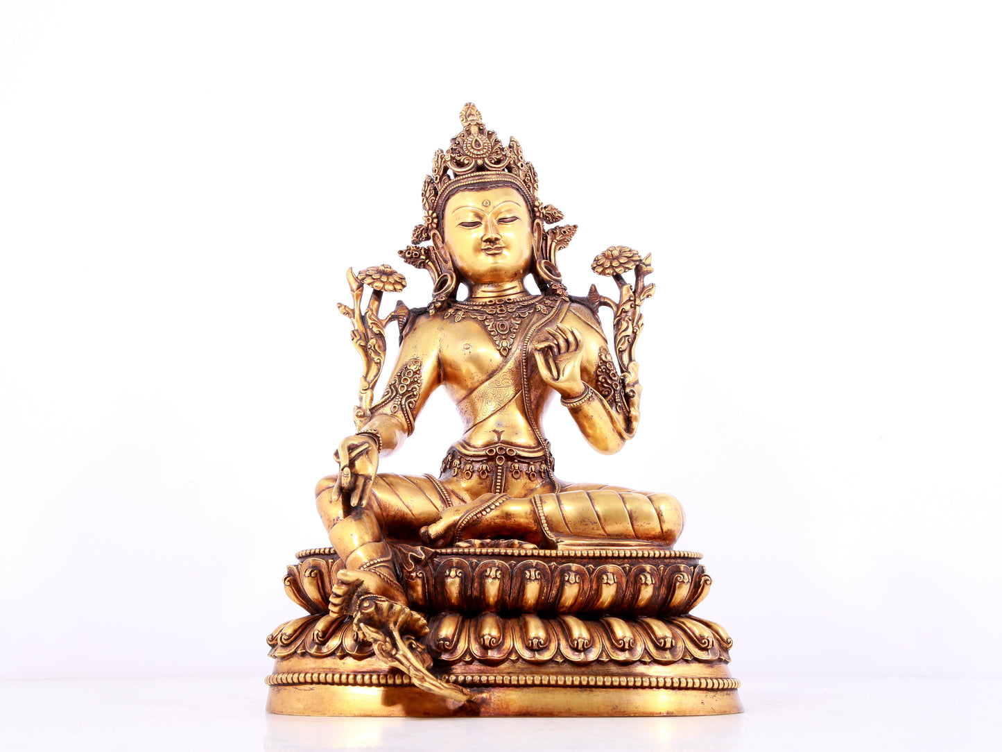 A solemn gilt bronze statue of green Tara