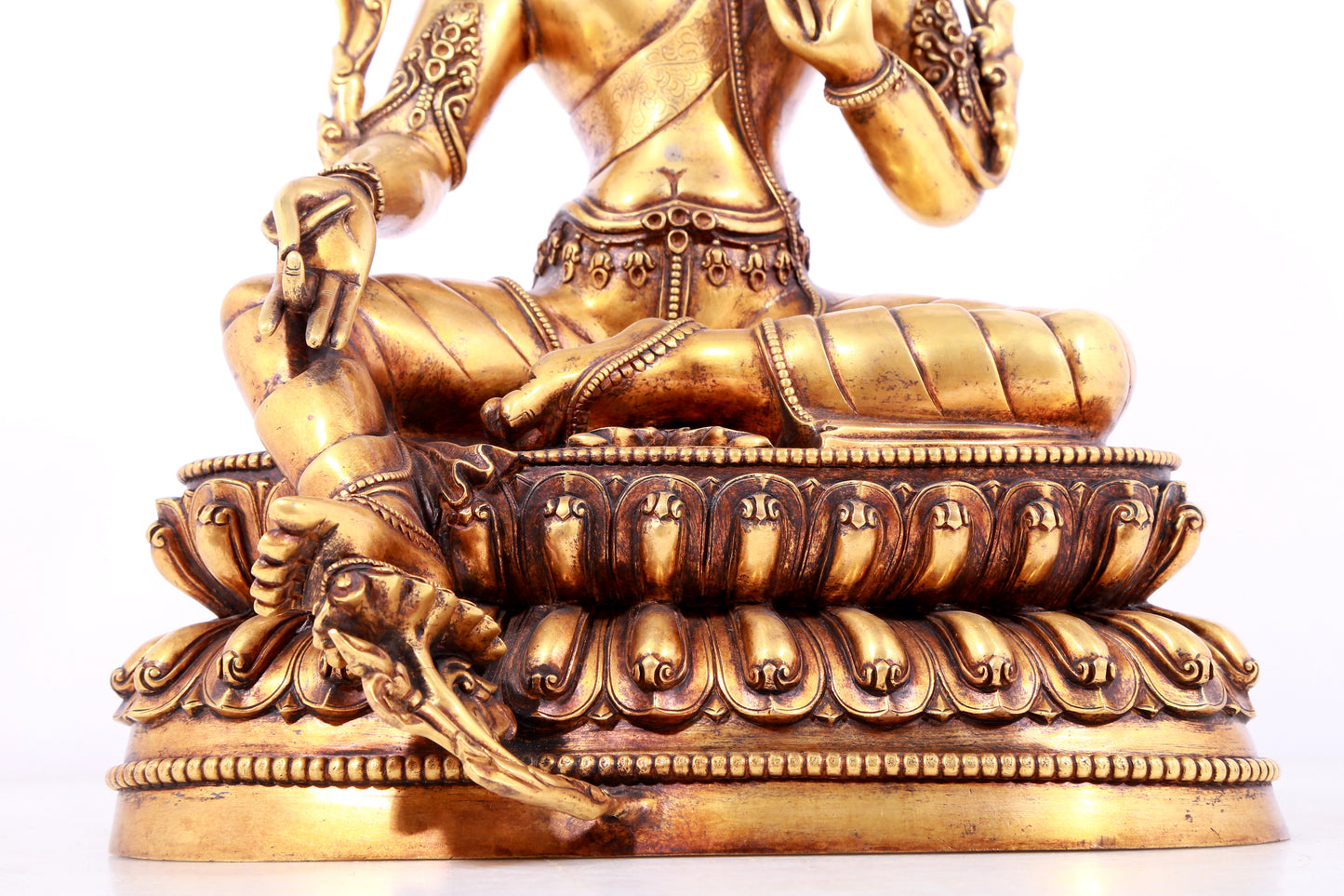 A solemn gilt bronze statue of green Tara