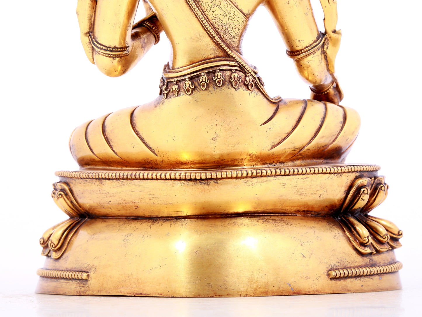 A solemn gilt bronze statue of green Tara