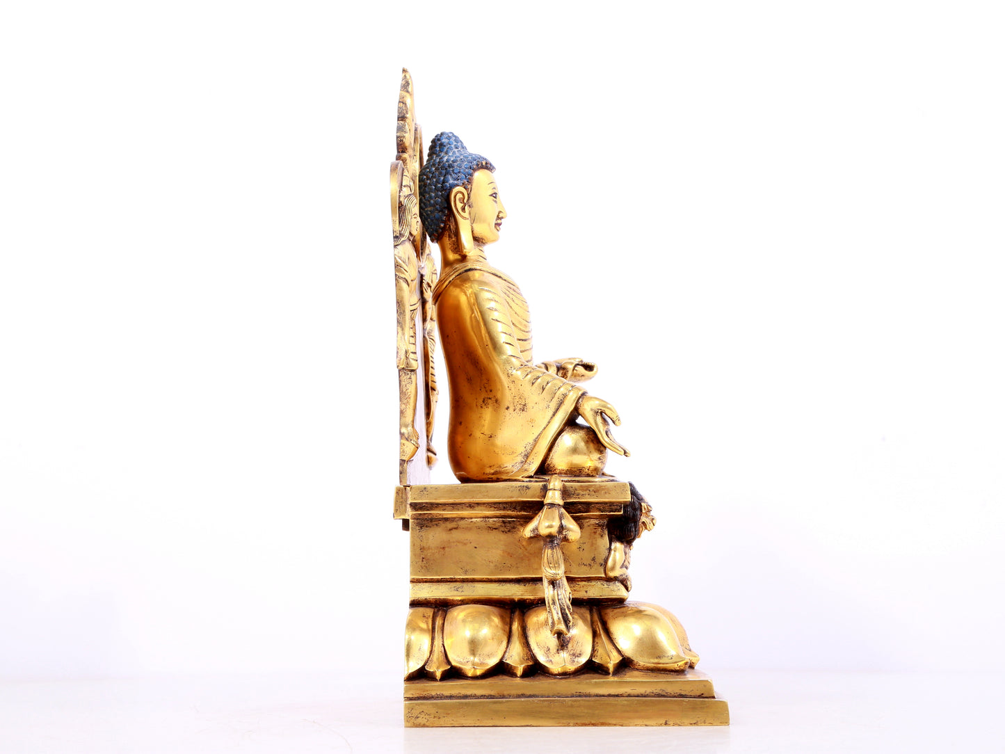 A solemn gilt bronze statue of Sakyamuni