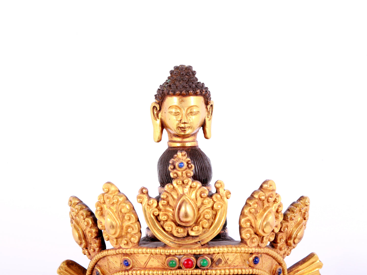 A solemn gilt bronze statue of Guanyin with four arms inlaid gems