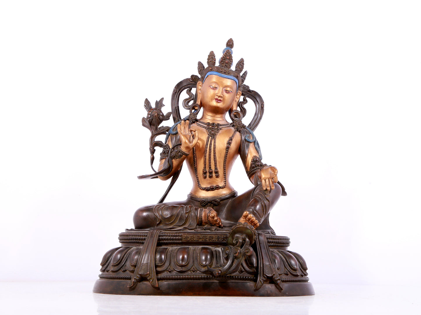 A solemn gilt bronze statue of green Tara