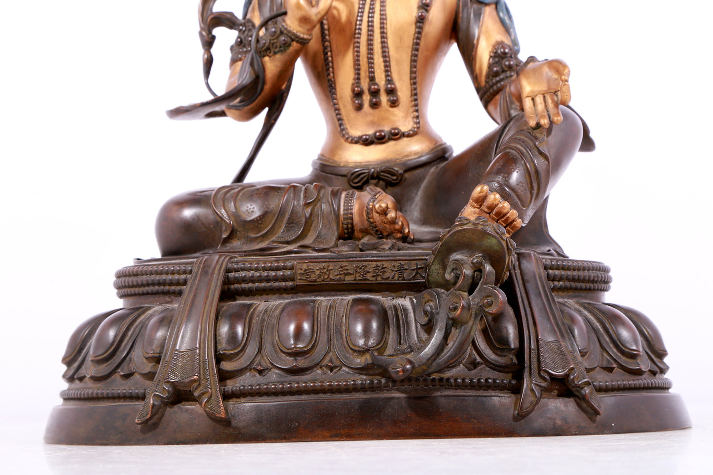 A solemn gilt bronze statue of green Tara