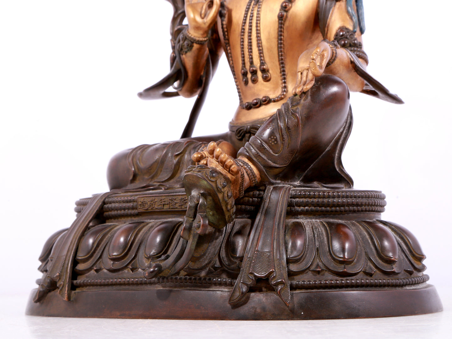 A solemn gilt bronze statue of green Tara