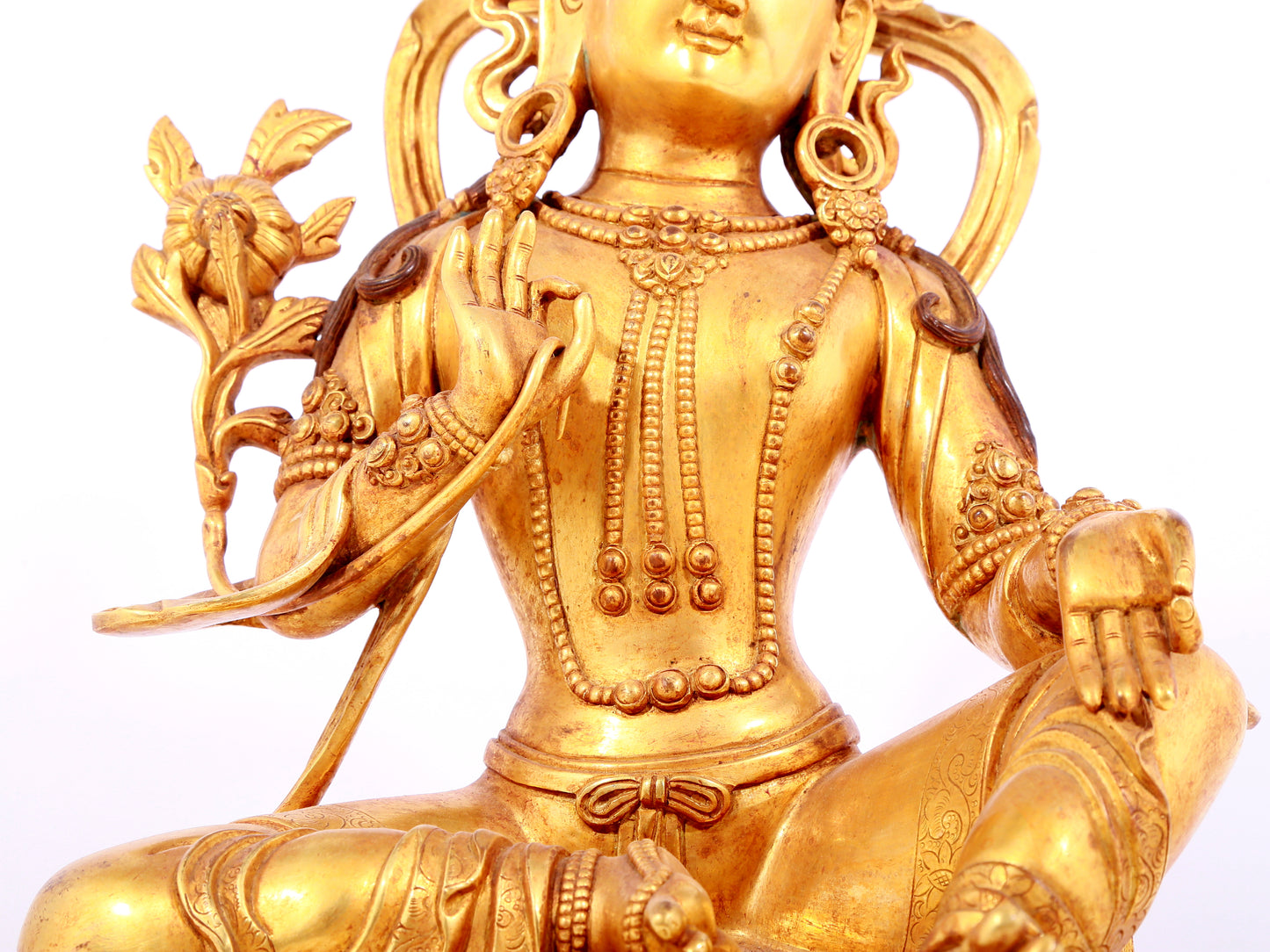 A solemn gilt bronze statue of green Tara