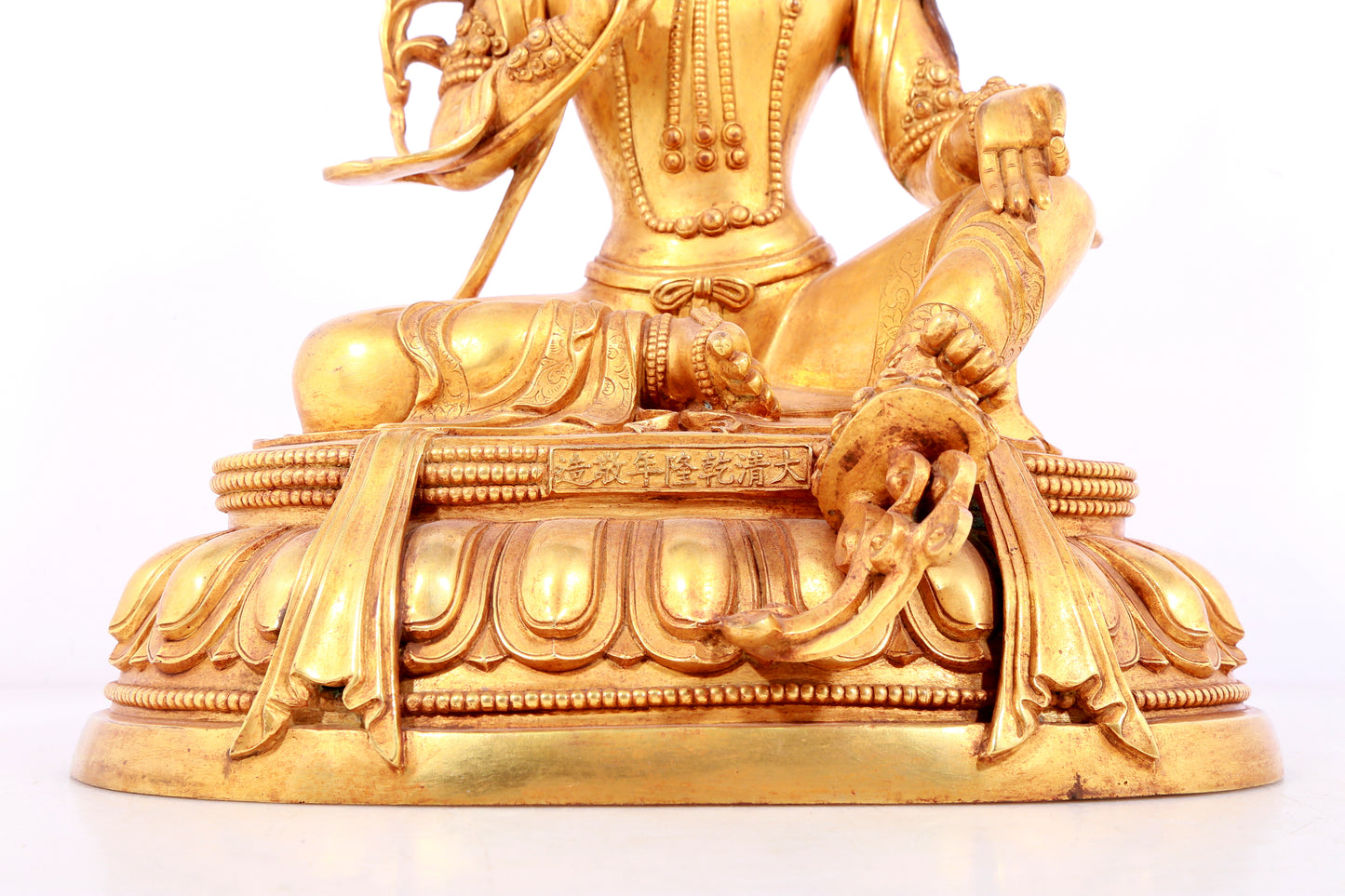 A solemn gilt bronze statue of green Tara